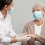 Assisted Living Nurse Wearing Perfect Touch Premium Latex Gloves